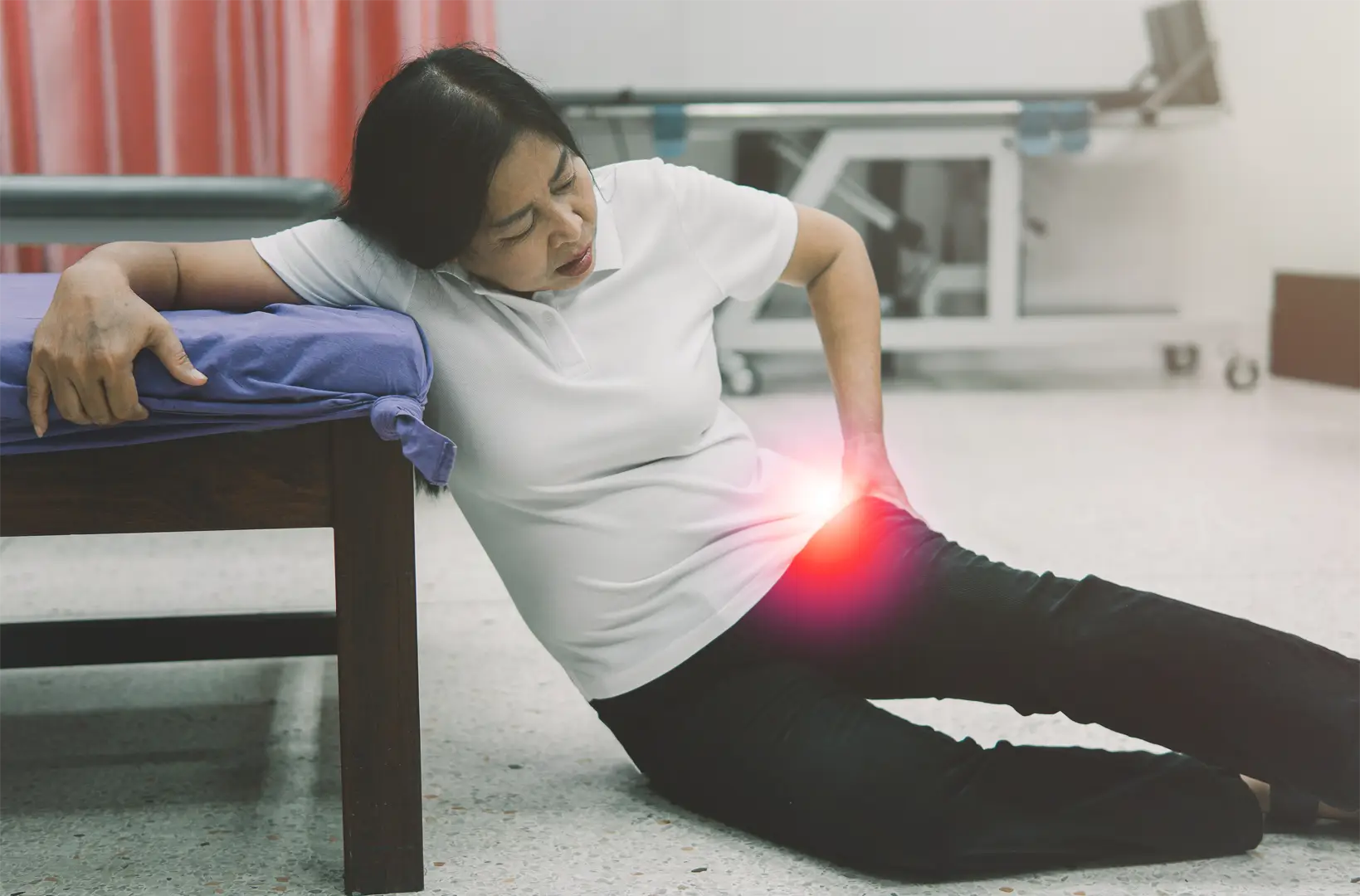 Older woman experiencing hip pain from trochanteric bursitis, highlighted on the greater trochanter area