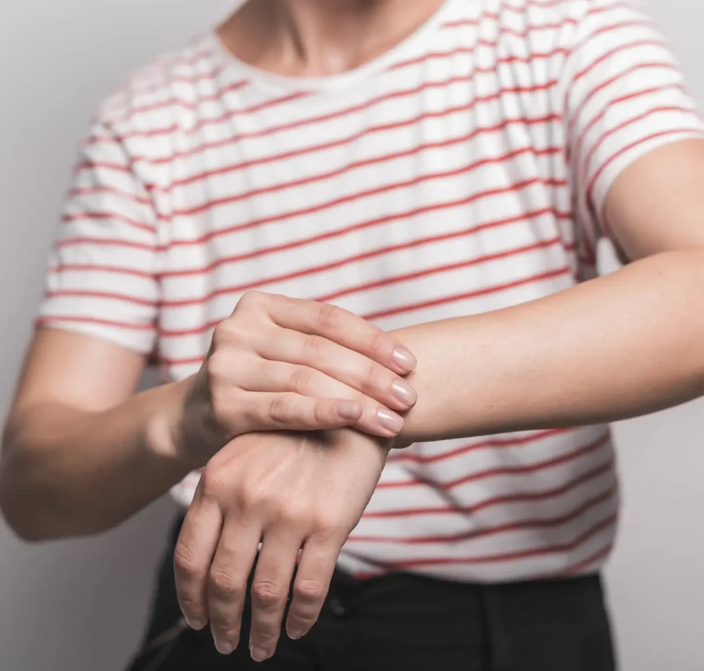 Woman holding her wrist in pain, showing signs of wrist discomfort or injury