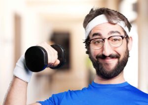 Smiling man doing dumbbell exercise, research shows regular physical activity increases brain volume and supports long-term brain health