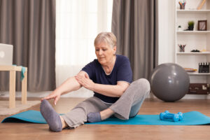 active old woman exercising yoga for knee pain