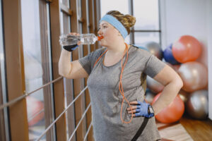 Woman doing strength training and staying hydrated while on Ozempic for weight loss – exercise helps preserve muscle during GLP-1 medication use in Ottawa